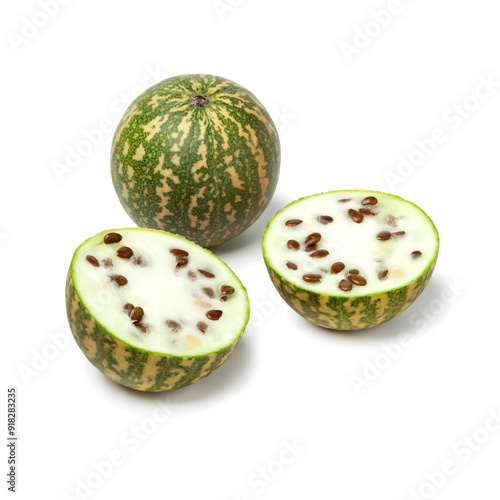 Whole and halved fresh red seeded citron melon  isolated on white background close up photo