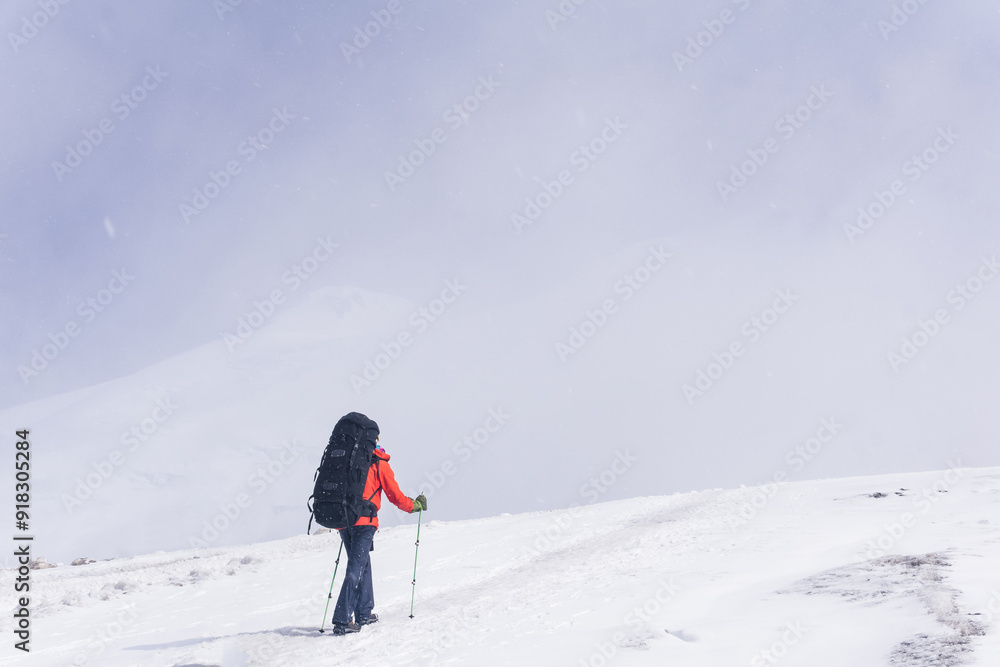 mountaineer climbs a snowy mountain peak mountaineer climbs a snowy mountain peak