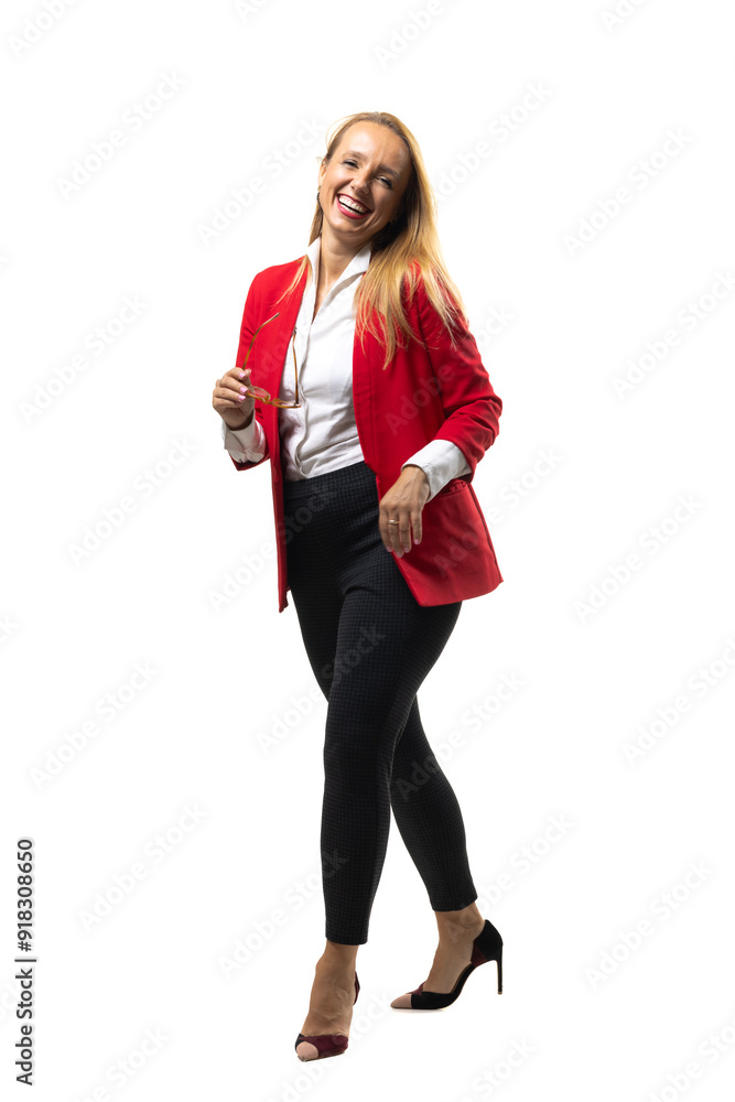 Confident businesswoman in a red blazer smiling and walking Confident businesswoman in a red blazer smiling and walking