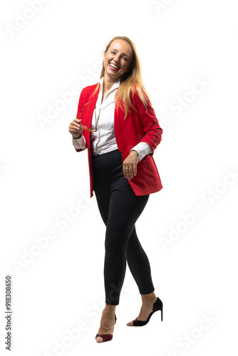 Confident businesswoman in a red blazer smiling and walking photo