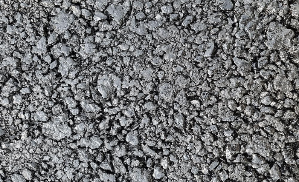 New laid asphalt road, large crushed stone. Close-up. Background. New laid asphalt road, large crushed stone. Close-up. Background.