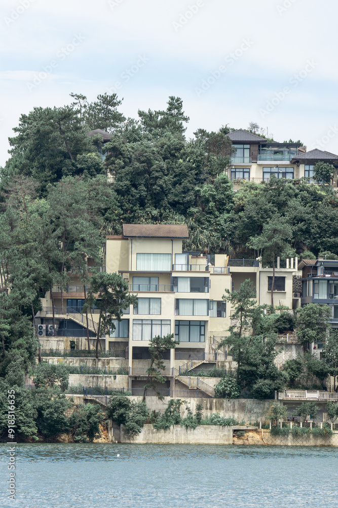 Fototapeta premium residential building on hill by lake