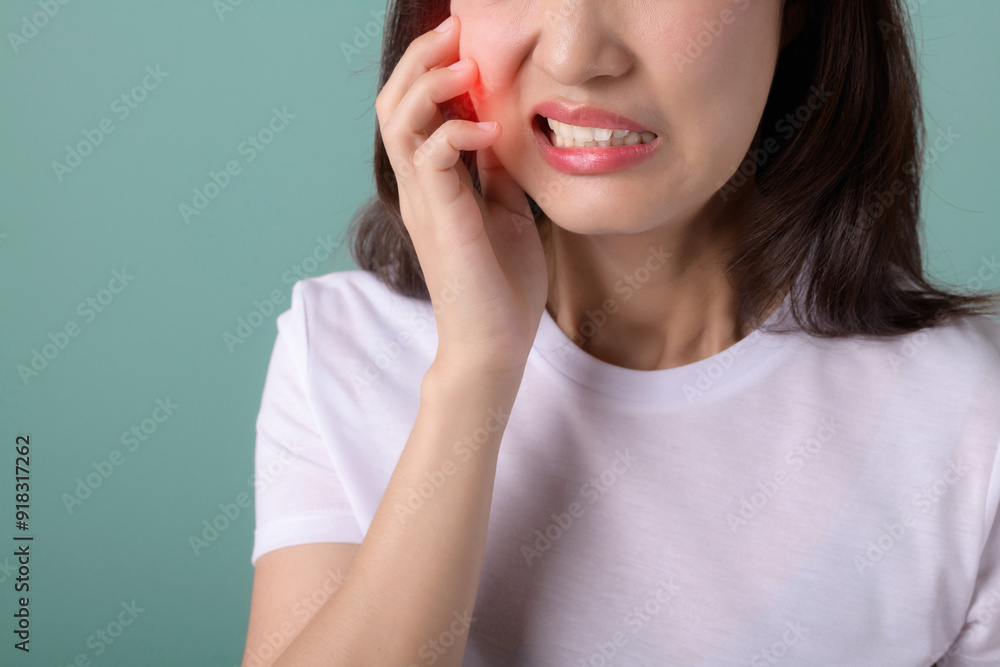 toothache jaw pain. asian young woman touching her mouth, expression, suffering from toothache, decay or sensitivity cavity molar tooth. toothache girl isolated on green background. toothache jaw pain. asian young woman touching her mouth, expression, suffering from toothache, decay or sensitivity cavity molar tooth. toothache girl isolated on green background.