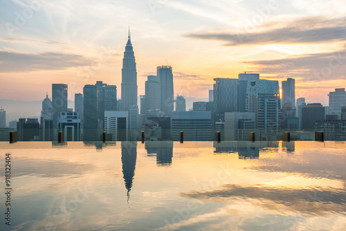 Canvas Print Kuala Lumpur city skyline with reflections of high-rise buildings and skyscrapers in infinity rooftop pool at sunrise, Malaysia