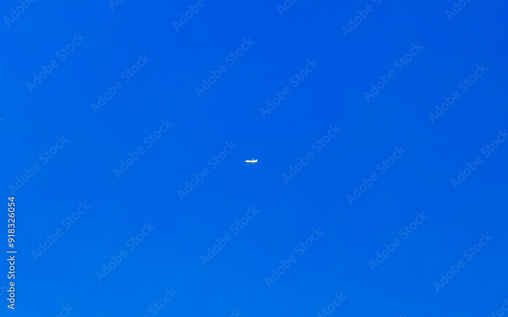 Passenger airplane flies in blue sky with clouds in Mexico. Passenger airplane flies in blue sky with clouds in Mexico.