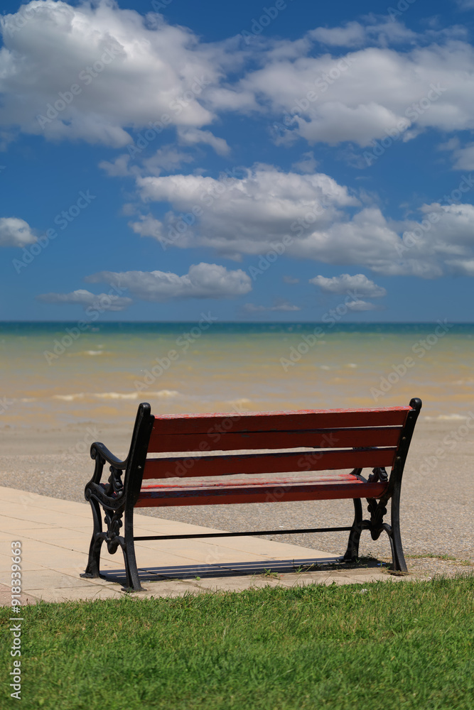 Wooden benches and sun loungers for relaxing on the embankment near the sea, public places Wooden benches and sun loungers for relaxing on the embankment near the sea, public places