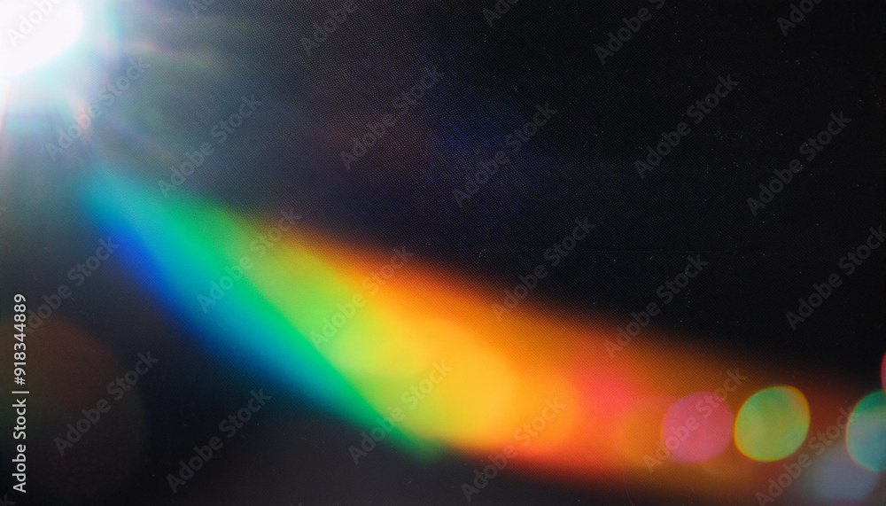 Obraz premium Abstract Light Refraction on Black Background. Spectrum of Rainbow Colors Blurred by Lens Flare, Featuring Vibrant Red, Orange, Green, and Blue Hues in a Soft, Ethereal Glow