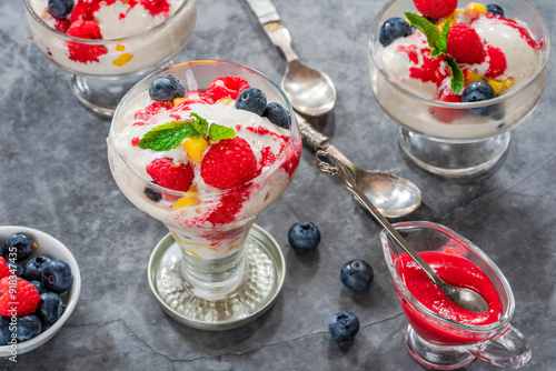 Vanilla ice cream dessert with fresh fruit and raspberry coulis photo