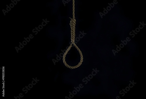 A noose made of rope hanging against a dark background, symbolizing suicide or depression