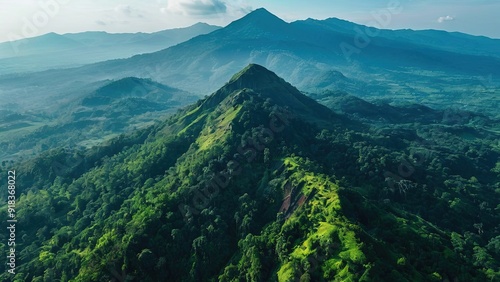 Amazing aerial view of dramatic mountains, green trees on mount sumbing, mountain sumbing in magelang indonesia. Beautiful nature drone flying over green forest mountain peaks photo