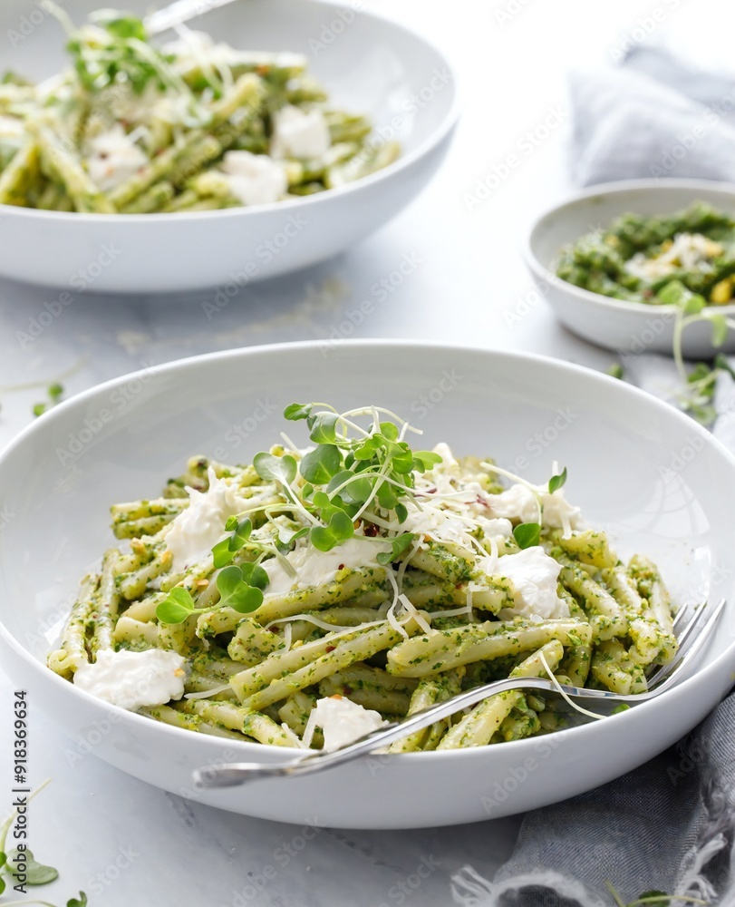 a bowl of pasta with pesto and cheese a bowl of pasta with pesto and cheese