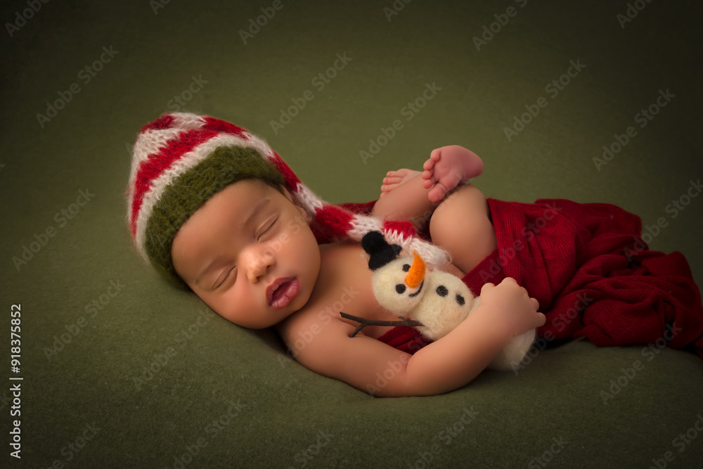 African newborn baby with christmas snowman African newborn baby with christmas snowman