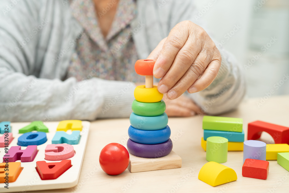 Alzheimer disease AD, Asian senior woman patient suffering from dementia learn practical motor skills rehabilitation. Alzheimer disease AD, Asian senior woman patient suffering from dementia learn practical motor skills rehabilitation.