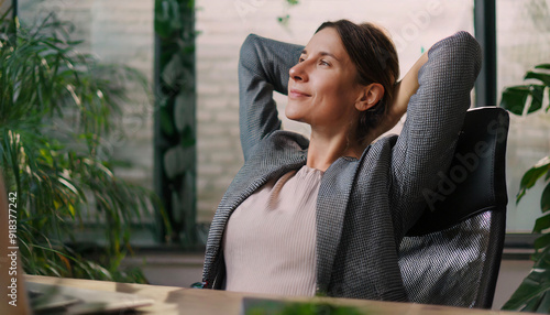 Close-up of a young businesswoman in the office doing stretching exercises.  photo