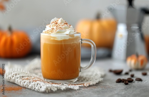 Creamy Pumpkin Spice Latte in a Cozy Setting With Seasonal Decorations
