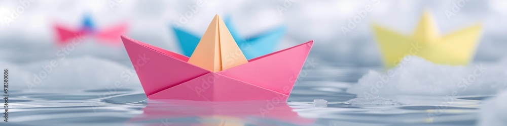 A group of paper origami boats floating in a water. A group of paper origami boats floating in a water.
