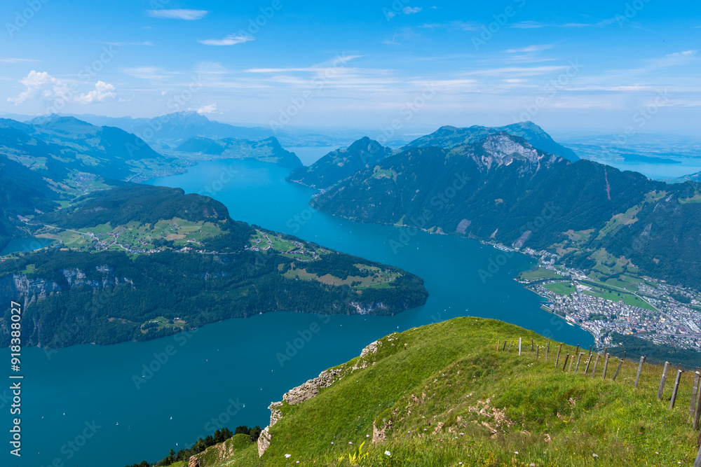 Fototapeta premium The Stoos hike in summer offers breathtaking views of the Swiss Alps, lush green meadows, and serene lakes. The trail is accessible yet challenging, with panoramic vistas that make every step rewardin