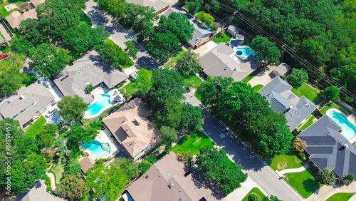 Green community environmentally friendly practices in upscale residential neighborhood suburbs Dallas, large suburban houses inground pool in North Arlington, Texas, urban vegetation, aerial view photo