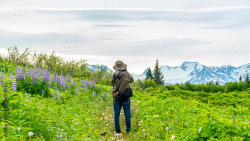 Photographer in the Alaska wilderness photographs mountains