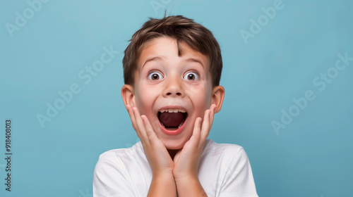 Excited young boy with wide eyes and open mouth 