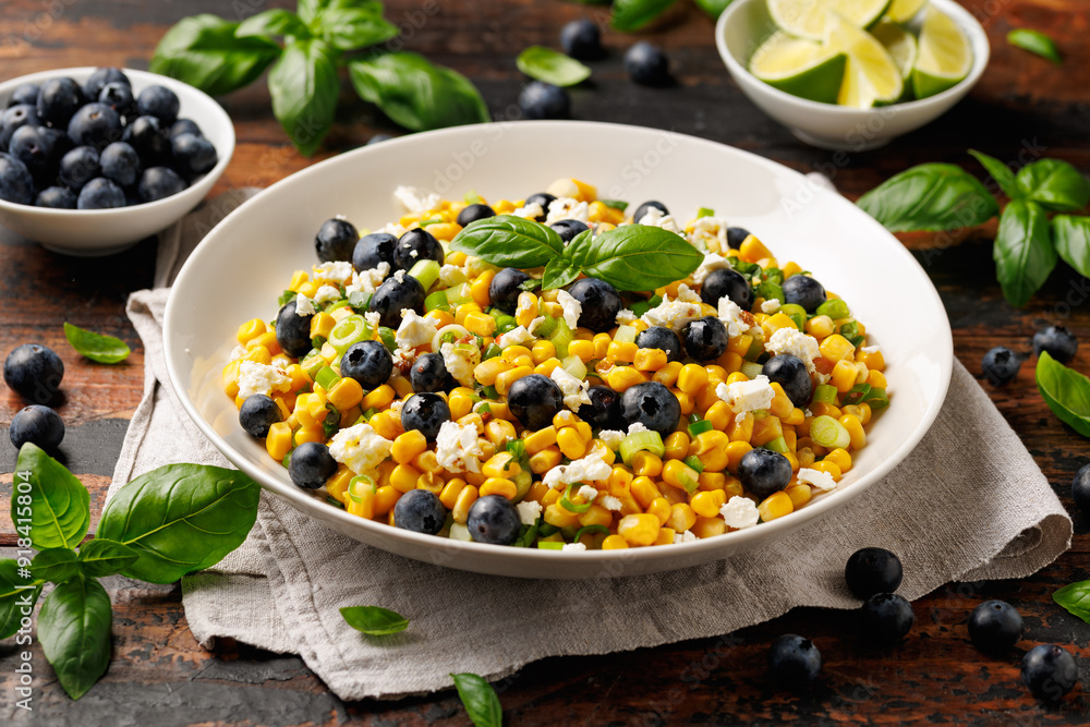 Blueberry Corn Feta Salad in white plate on wooden table. Healthy food Blueberry Corn Feta Salad in white plate on wooden table. Healthy food