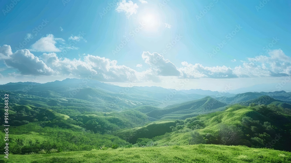 Fototapeta premium A breathtaking landscape showcasing rolling green hills under a bright blue sky with fluffy clouds and radiant sunlight.