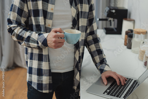 High angle view of an young brunette working at her office desk with documents and laptop.