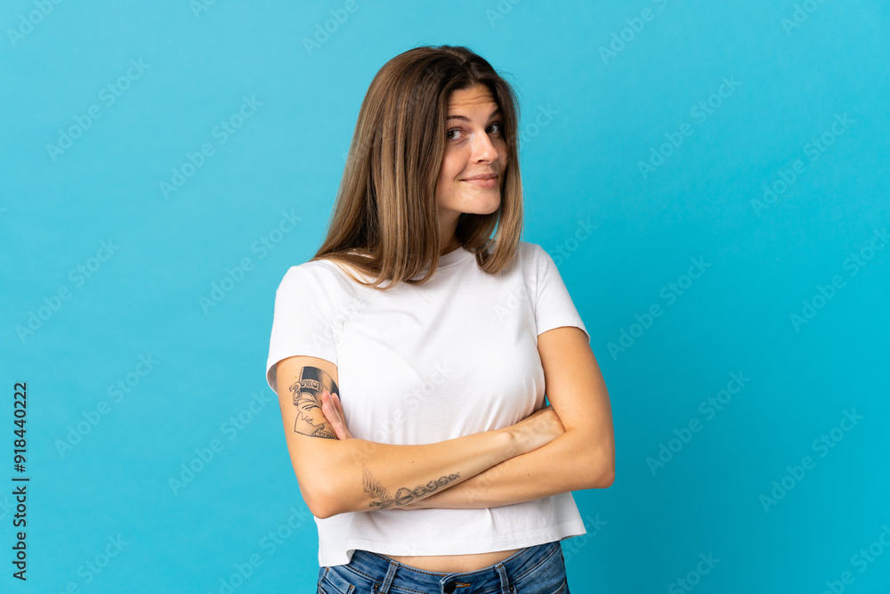 Young slovak woman isolated on blue background making doubts gesture while lifting the shoulders