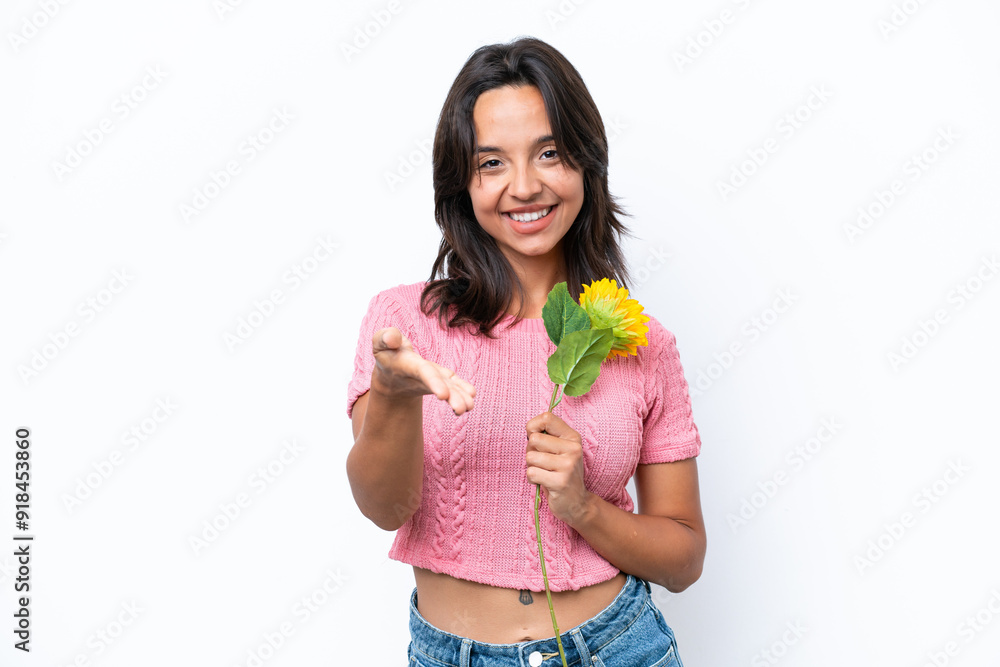 Young hispanic woman holding sunflower isolated on white background shaking hands for closing a good deal Young hispanic woman holding sunflower isolated on white background shaking hands for closing a good deal