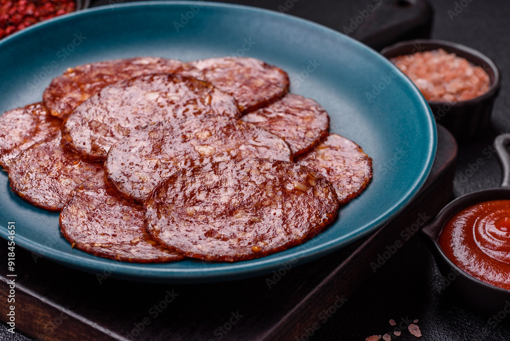 Delicious smoked pepperoni sausage sliced with salt, spices and herbs Delicious smoked pepperoni sausage sliced with salt, spices and herbs