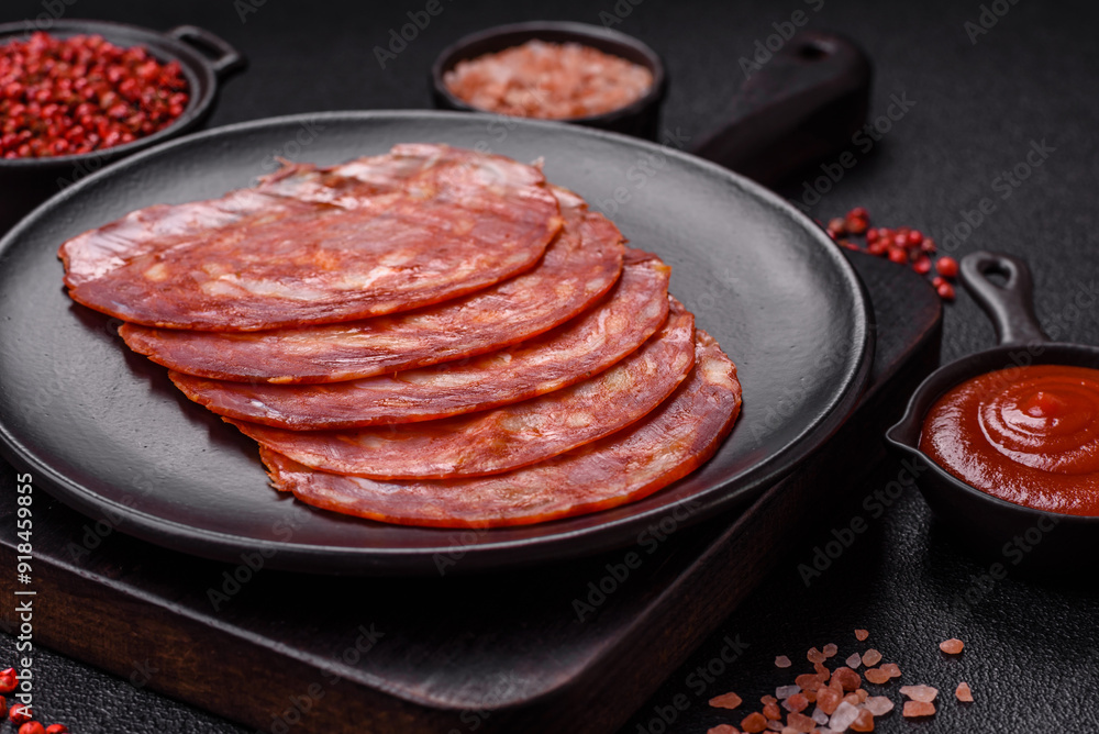 Delicious smoked meat sliced with salt, spices and herbs Delicious smoked meat sliced with salt, spices and herbs