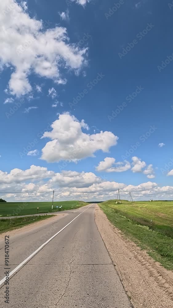 The car drives along the road on a summer day. Highways, roadside and road line markings. The car drives along the road on a summer day. Highways, roadside and road line markings.