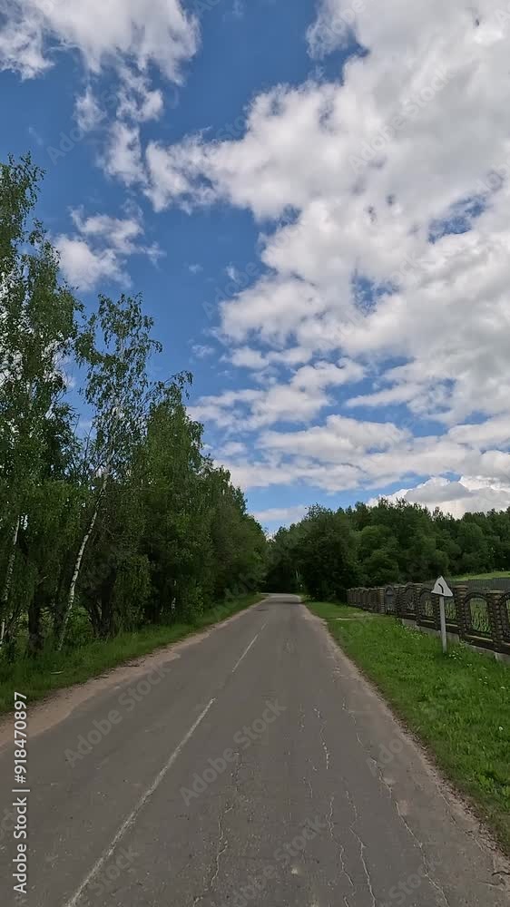 The car drives along the road on a summer day. Highways, roadside and road line markings. The car drives along the road on a summer day. Highways, roadside and road line markings.