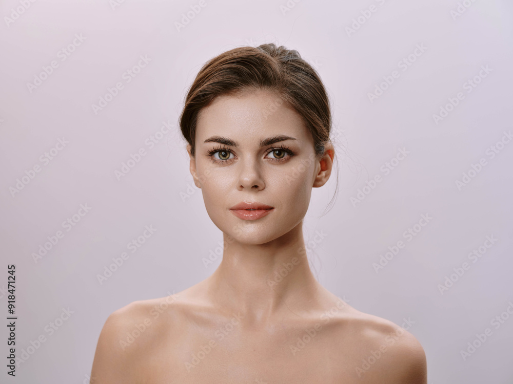 Beautiful young woman posing on a light pink background Beautiful young woman posing on a light pink background