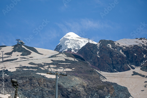 the glaciated broad horn seen from the western side from the aosta valley under a blue sunny sky  photo