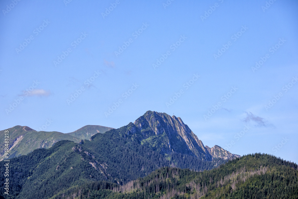 Obraz premium mountain landscape with several mountain peaks and blue sky