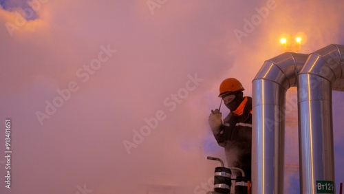 Industrial worker operating in extreme conditions, surrounded by steam and pipes. Human resilience in harsh environments. Focus on safety and efficiency in high-pressure industrial settings.
