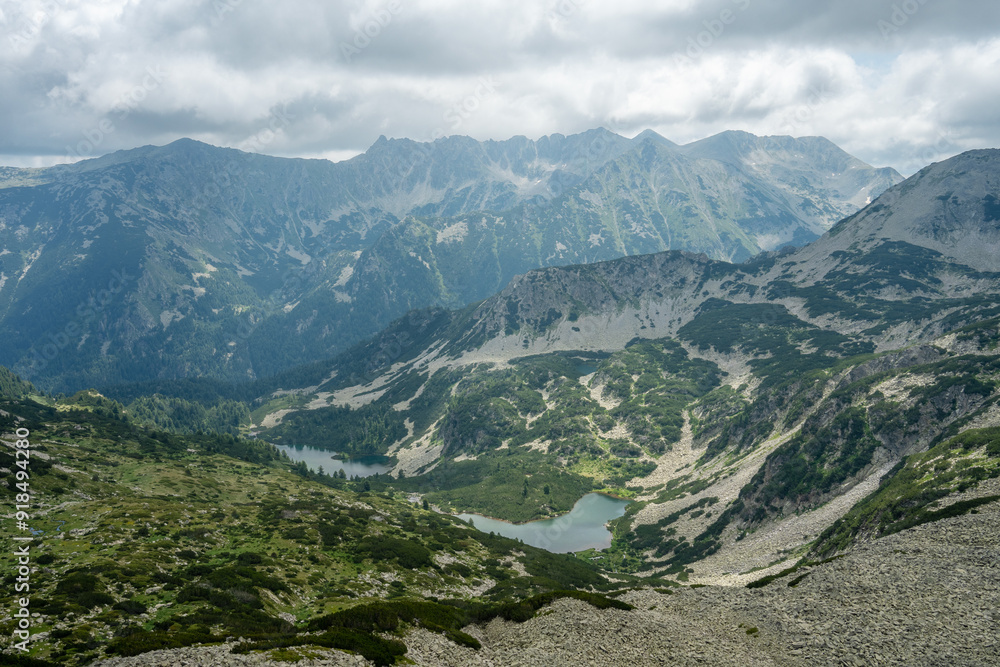 Upper and lower Vasilashki lakes under overcast sky captured from a ridge next to Todorka in June Upper and lower Vasilashki lakes under overcast sky captured from a ridge next to Todorka in June