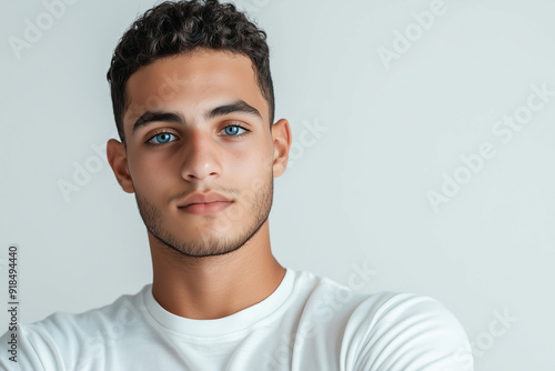 Confident Young Man with Curly Hair and Blue Eyes, White Background, Casual Style photo