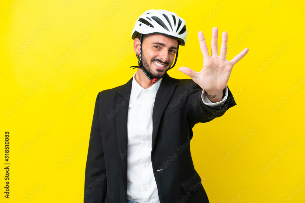 Business caucasian man with a bike helmet isolated on yellow background counting five with fingers Business caucasian man with a bike helmet isolated on yellow background counting five with fingers