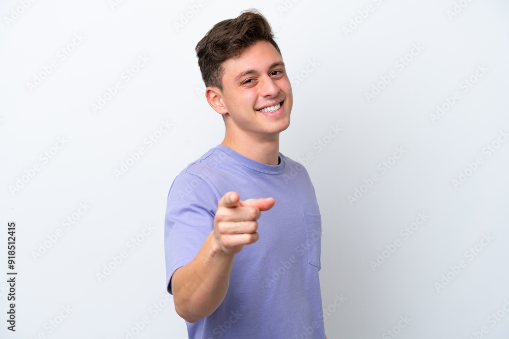 Young handsome Brazilian man isolated on white background pointing front with happy expression Young handsome Brazilian man isolated on white background pointing front with happy expression