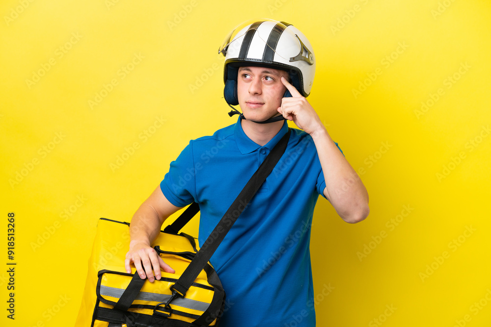 Young Brazilian man with thermal backpack isolated on yellow background having doubts and thinking Young Brazilian man with thermal backpack isolated on yellow background having doubts and thinking
