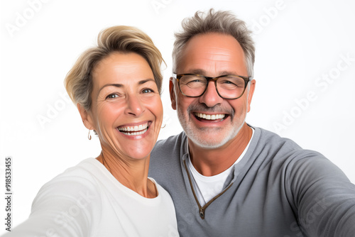 Middle aged couple over isolated white background making a selfie