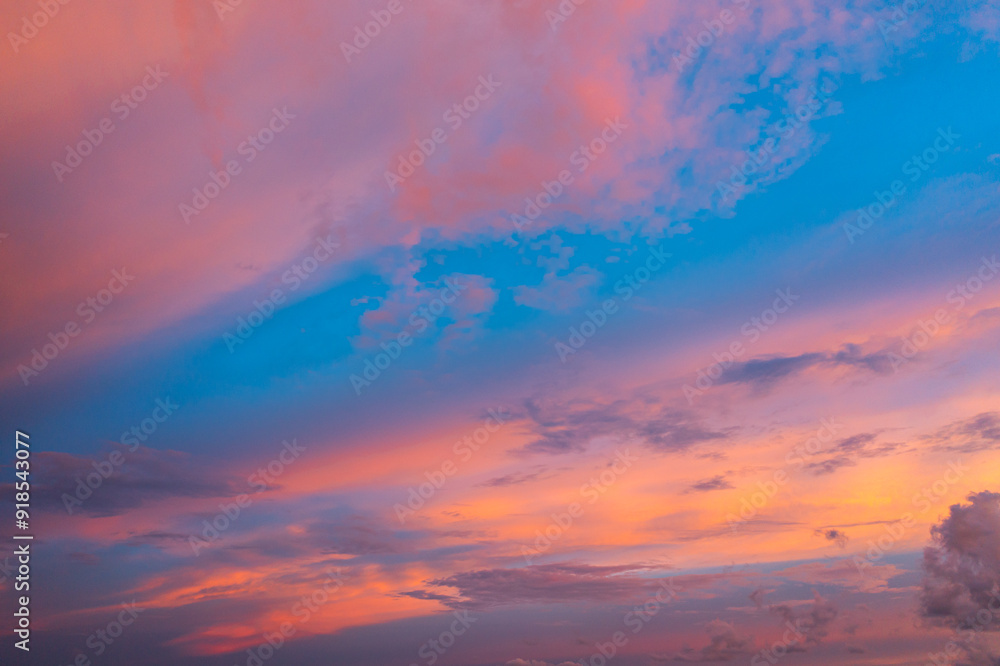 Fototapeta premium A breathtaking aerial view capturing a vibrant sunset over the Phuket countryside. The sky is ablaze with rich hues of yellow, orange, pink, and purple, while dramatic clouds float above the city