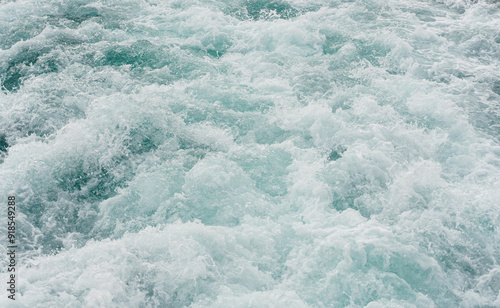 Dynamic close-up of foamy ocean waves in motion, perfect for projects related to nature, water dynamics, and the power of the sea. photo