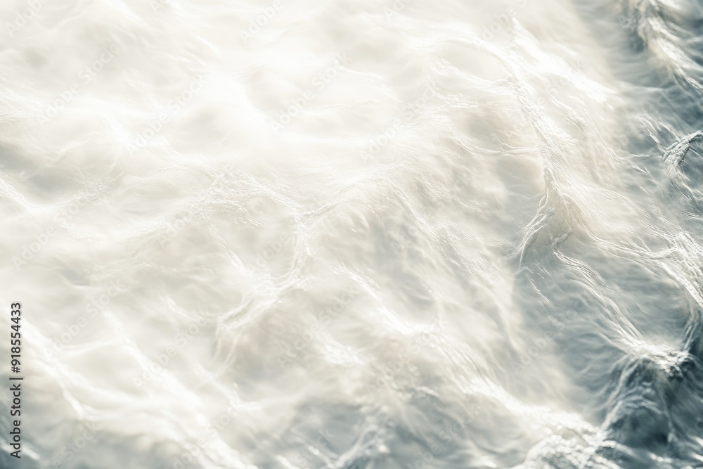 Obraz premium A tranquil white water wave light surface creates subtle ripples, showcasing the beauty of nature's textures and movements in soft diffused light