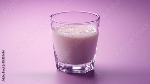 Milk in a Glass on Purple Background