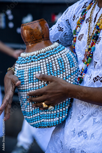 Afro Brazilian shekere beaded gourd drum close-up with colorful beads. photo