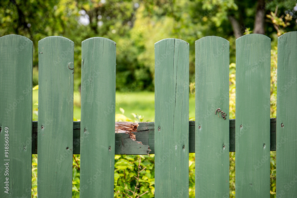 Fototapeta premium Missing board on wooden and broken fence