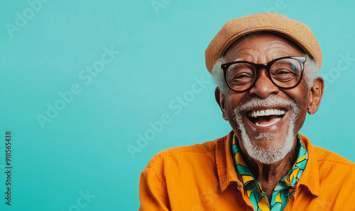 Smiling black senior man, isolated teal blue color background, image with space for text
